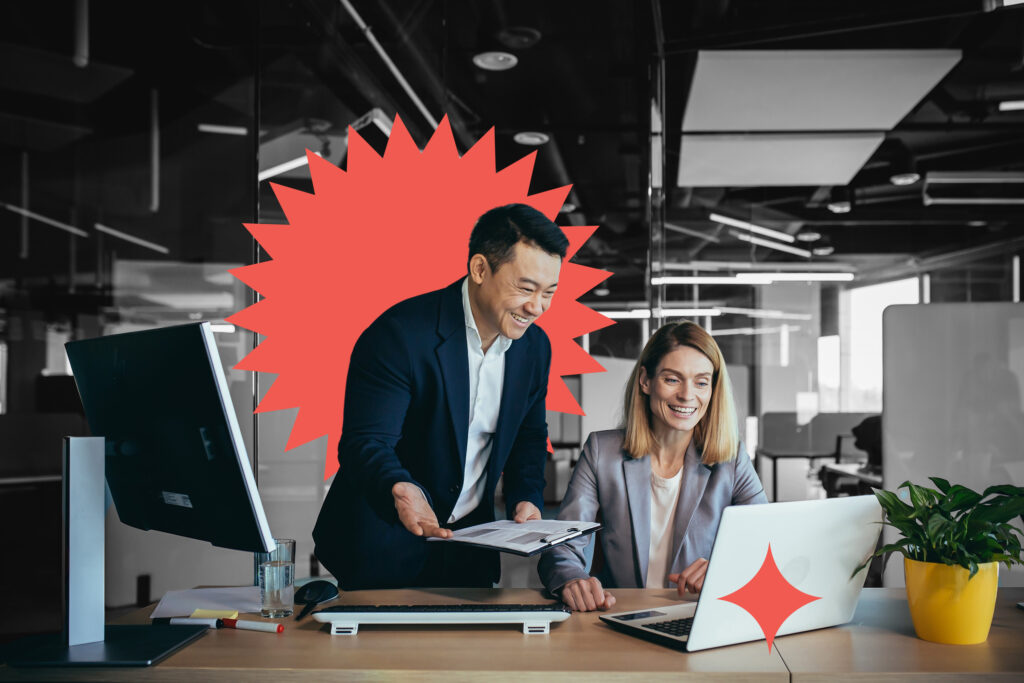 Two employees in a modern office, an Asian man and a woman working at a table, colleagues discussing and consulting, thinking about a joint project